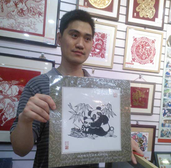 中国代表团张钧展示熊猫剪纸